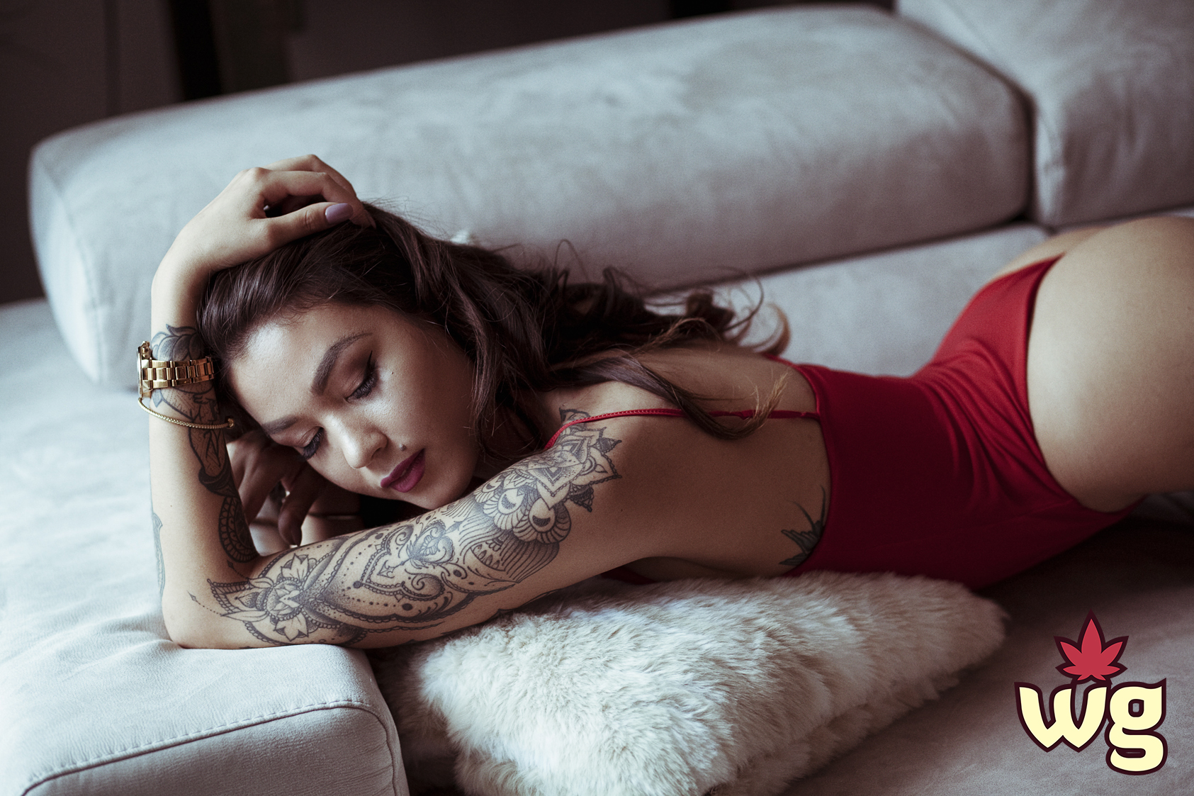 Hot tattooed woman posses in red bodysuit | Weed girls