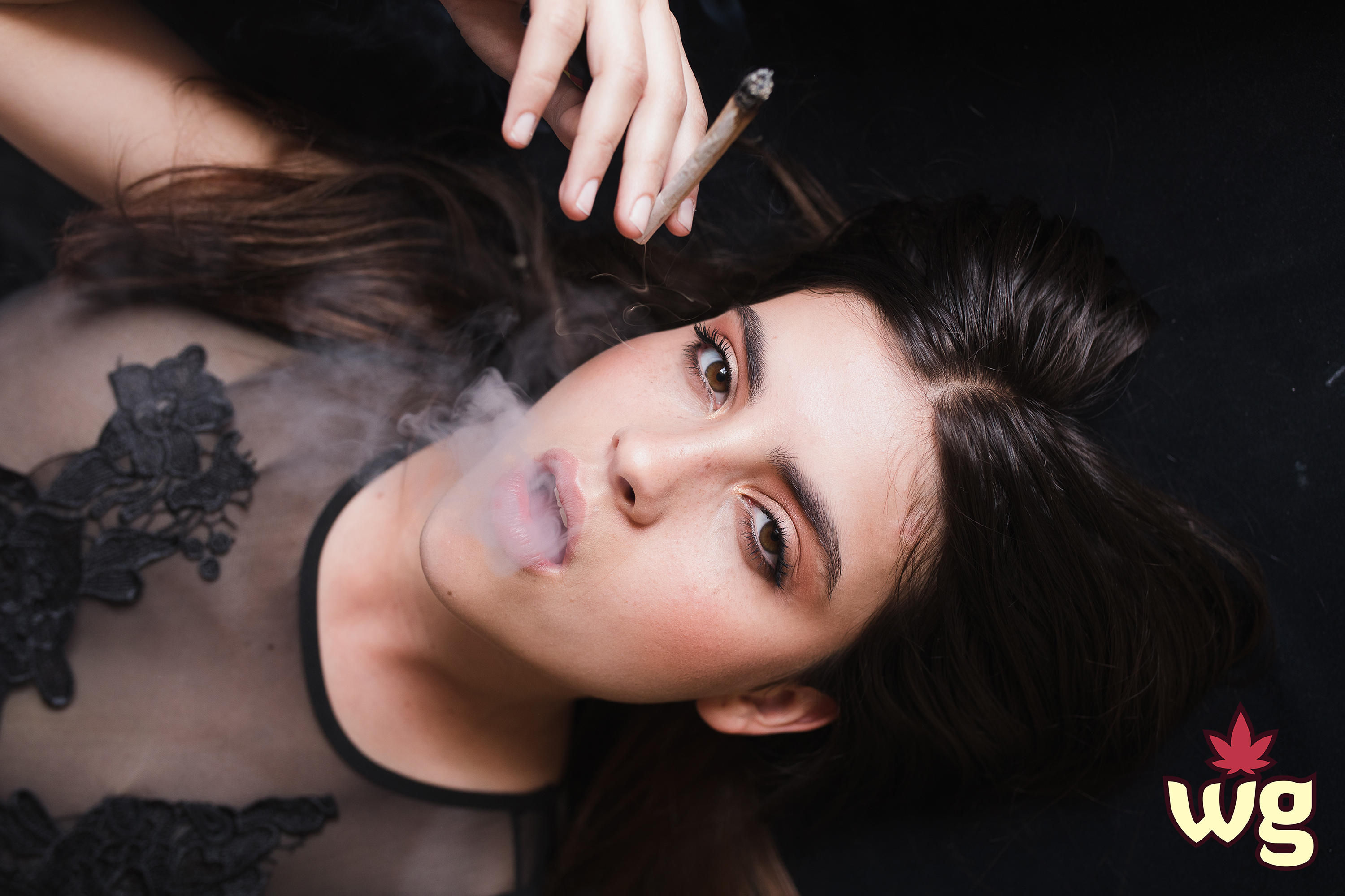 sexy woman in black bodysuit smoking weed